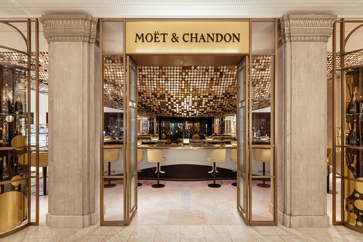 Experience London’s royal history while savoring exquisite Imperial Brut champagne at the iconic Moët & Chandon bar in Harrods surrounded by stunning luxury and elegance.